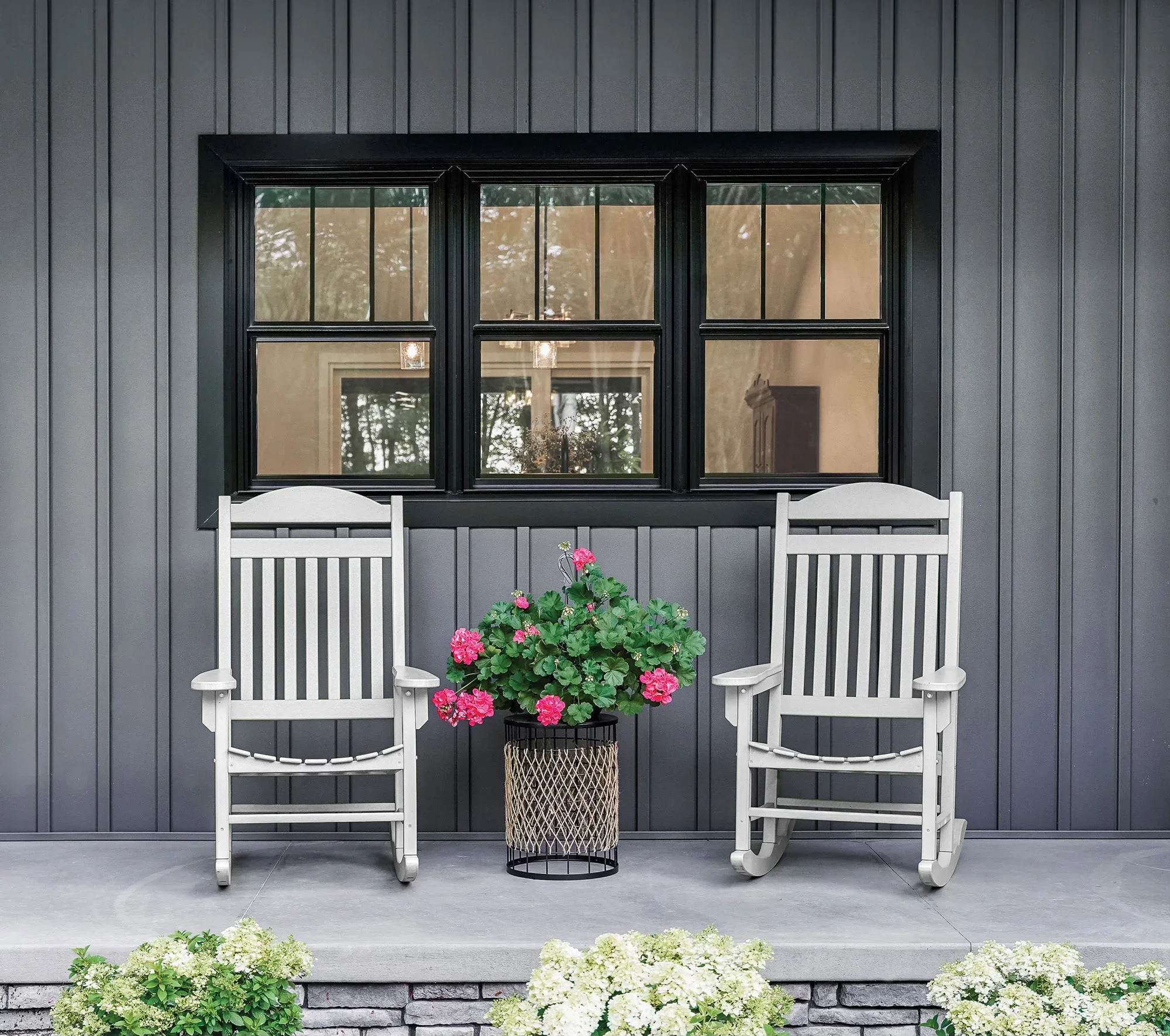 Black aluminum 6-over-6 grid windows installed on gray vertical siding with white trim